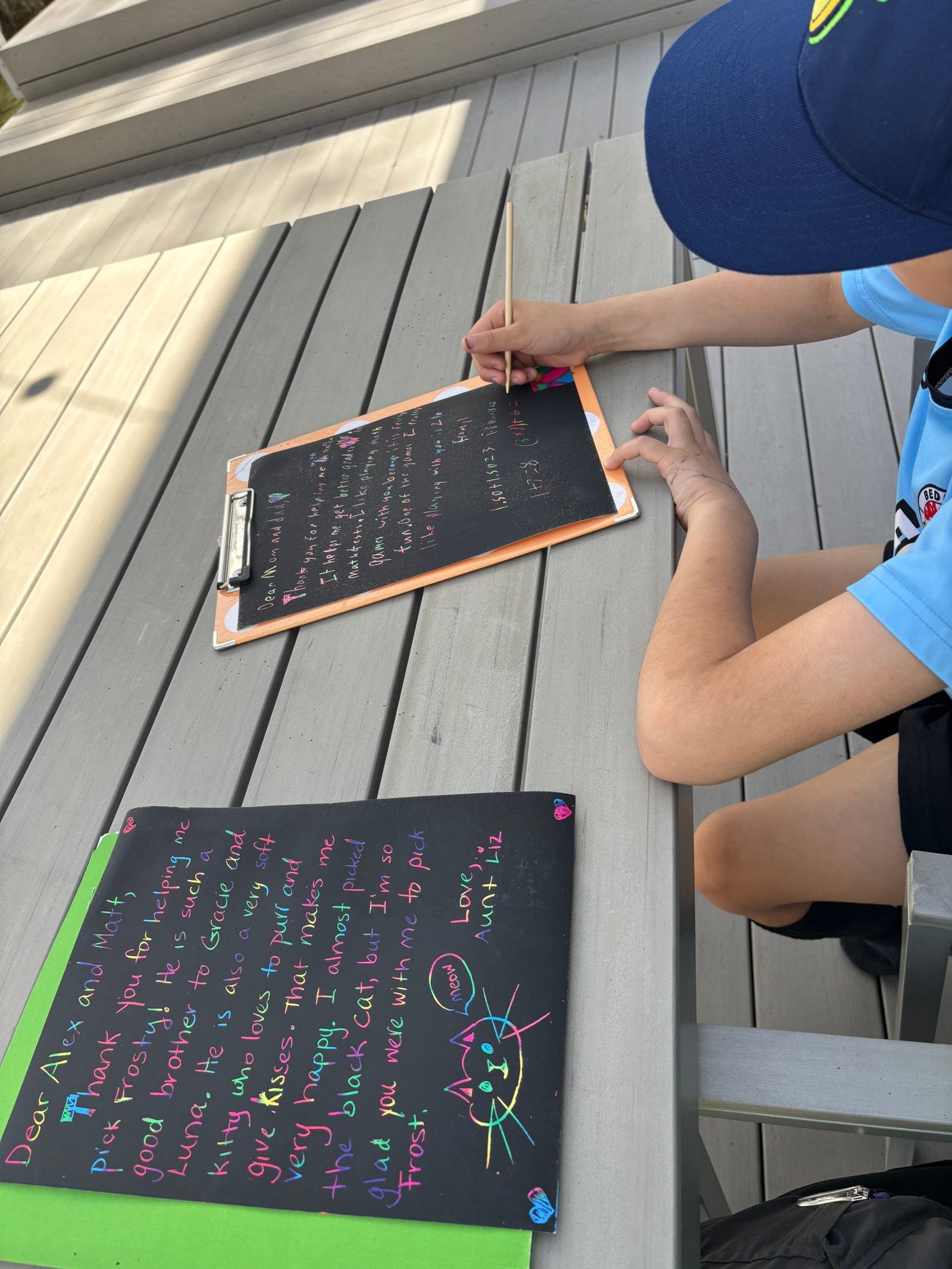 Student writing a thank-you note on scratch paper