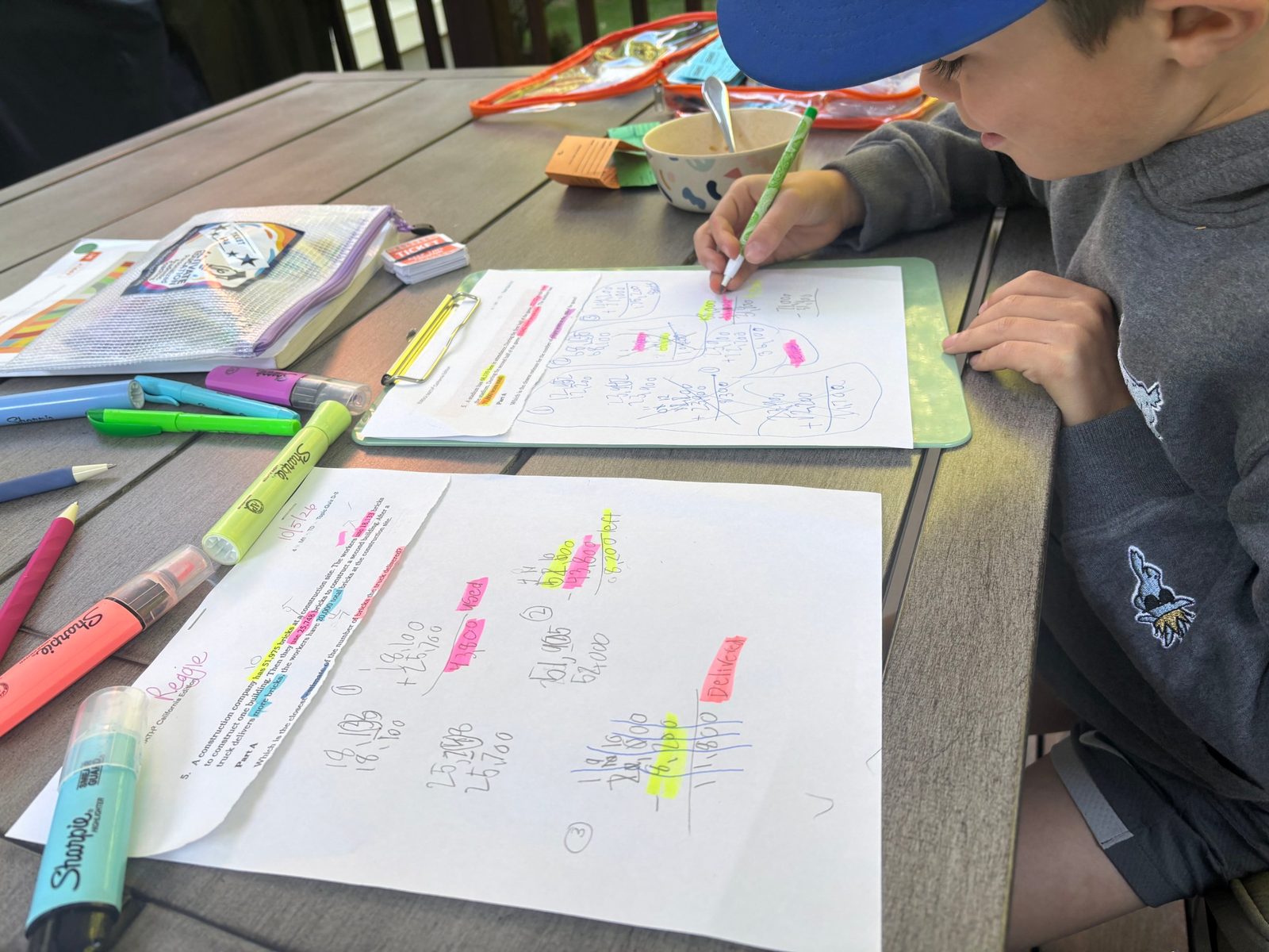 Student annotating a multi-step math problem with highlighters
